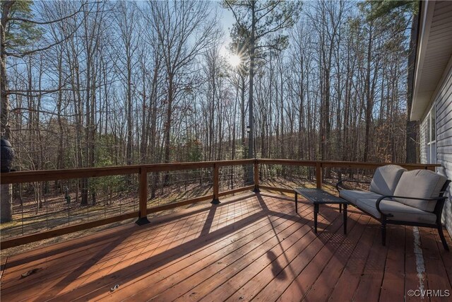 wooden deck with a view of trees