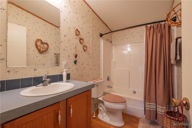 bathroom featuring vanity, shower / bathtub combination with curtain, wallpapered walls, a textured ceiling, and toilet