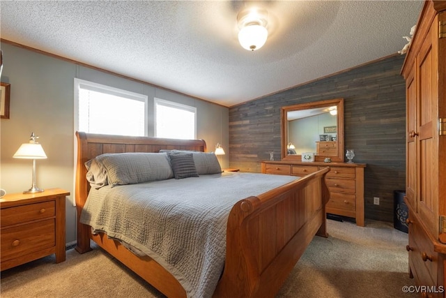 bedroom with wooden walls, light colored carpet, a textured ceiling, and vaulted ceiling