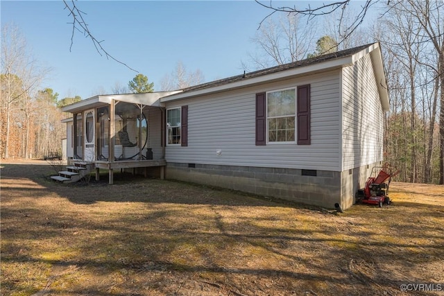 exterior space with crawl space, a yard, and a sunroom