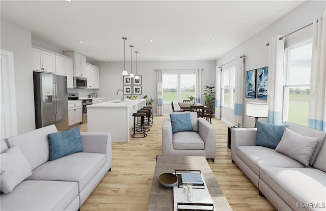 living area with light wood-type flooring and recessed lighting