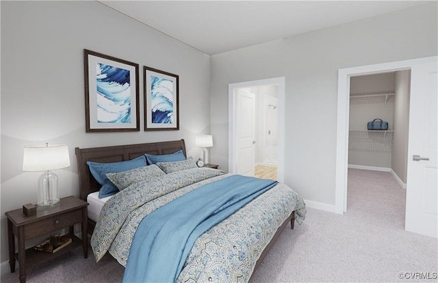 bedroom with baseboards, connected bathroom, a spacious closet, carpet flooring, and a closet