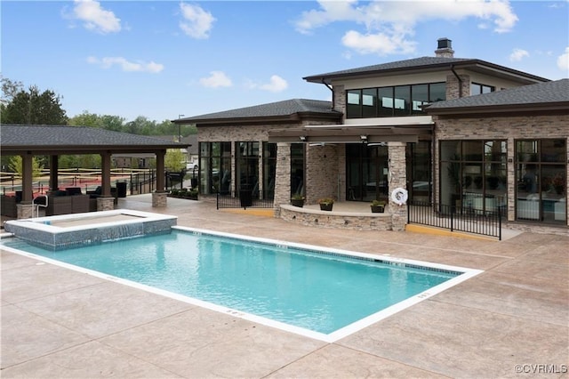 community pool featuring a patio, a hot tub, and fence