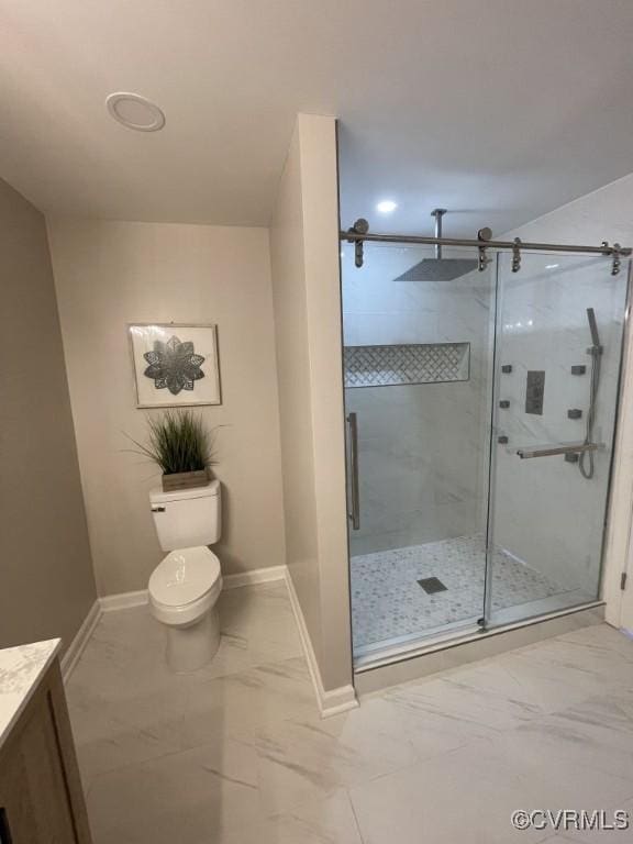 bathroom featuring marble finish floor, a shower stall, baseboards, and vanity