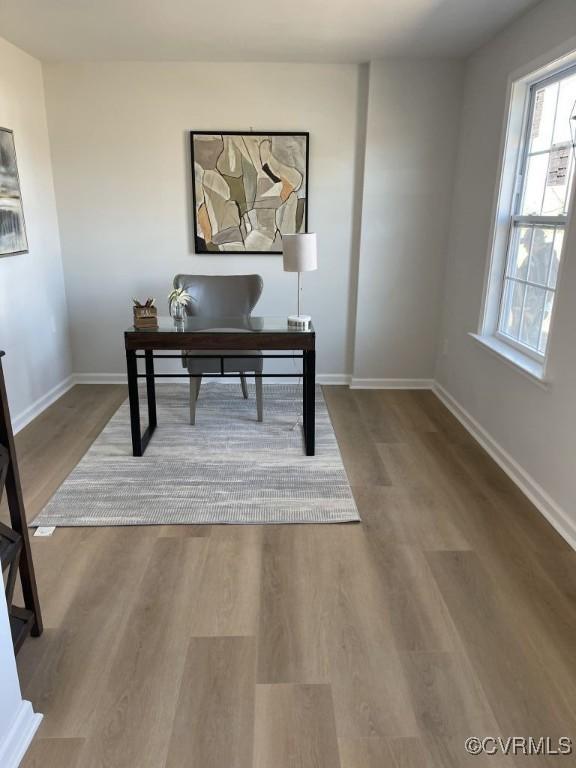 home office featuring baseboards and wood finished floors