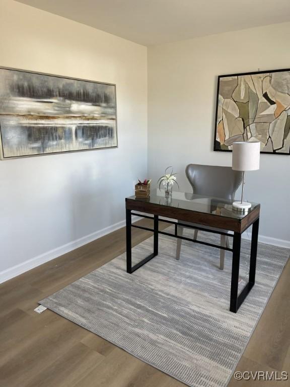 home office featuring baseboards and wood finished floors