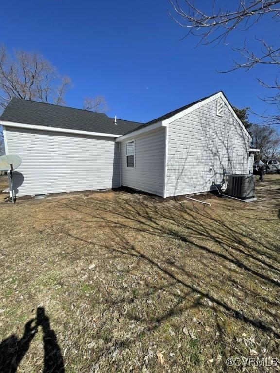 view of side of home featuring central AC unit