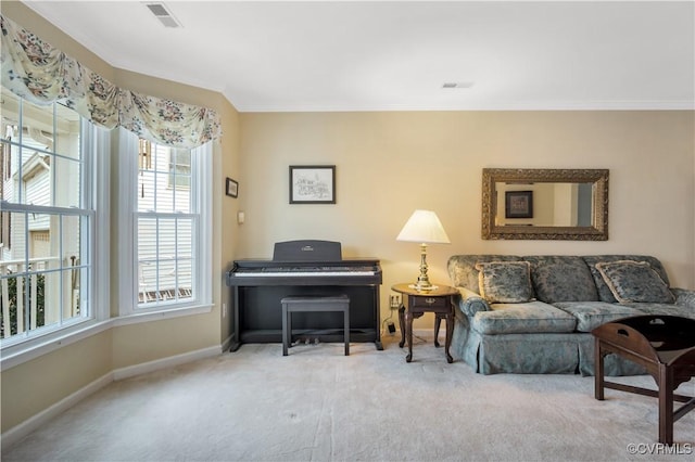 carpeted living room with visible vents, baseboards, and crown molding