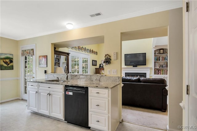 kitchen with light stone counters, visible vents, white cabinetry, a sink, and dishwasher