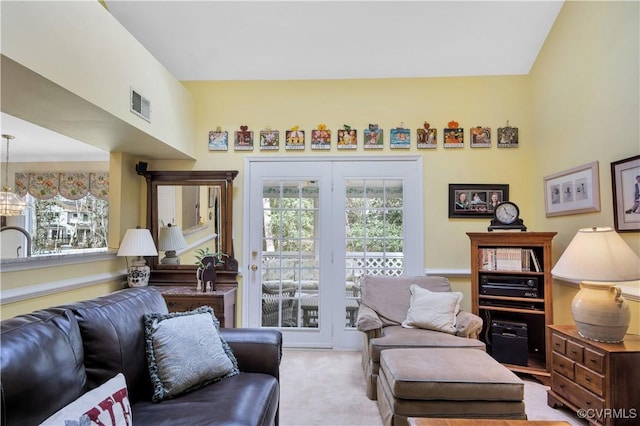 living area featuring carpet flooring, visible vents, and a wealth of natural light