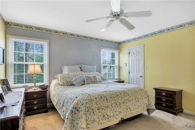 bedroom with baseboards, light colored carpet, and ceiling fan