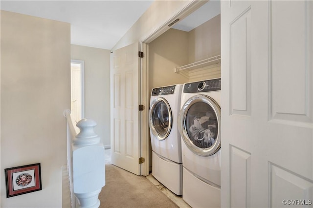 laundry area with light colored carpet, separate washer and dryer, and laundry area