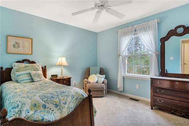 bedroom featuring visible vents, a ceiling fan, baseboards, and light carpet