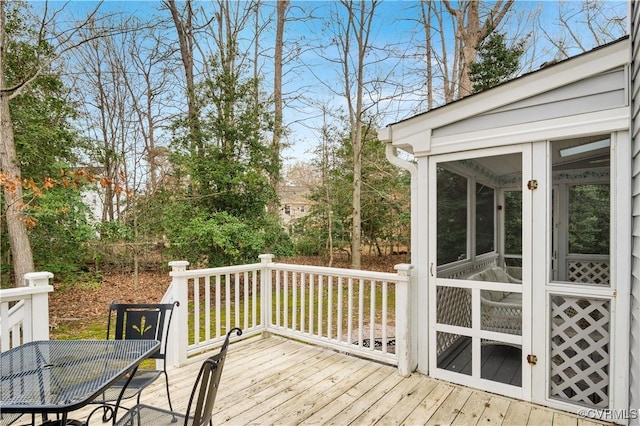 wooden deck featuring a sunroom