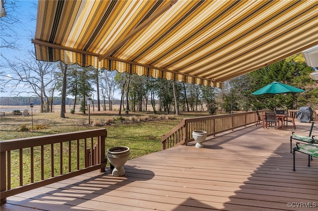 wooden terrace with outdoor dining area