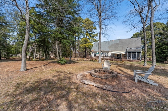 view of yard with an outdoor fire pit