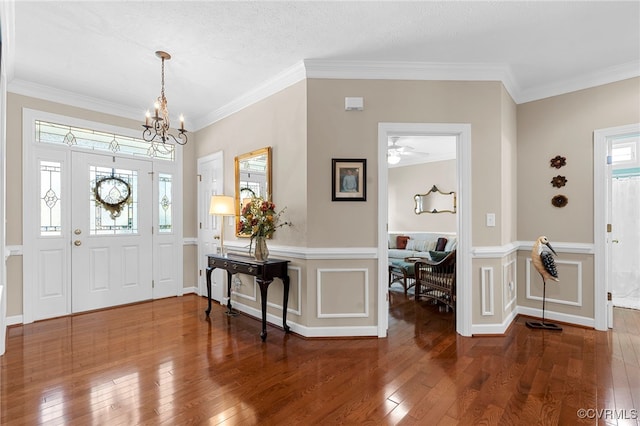 foyer entrance featuring crown molding and hardwood / wood-style floors
