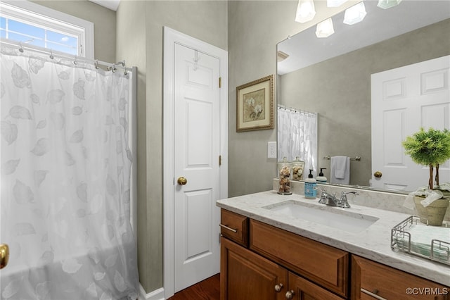 bathroom with a shower with curtain, vanity, and wood finished floors
