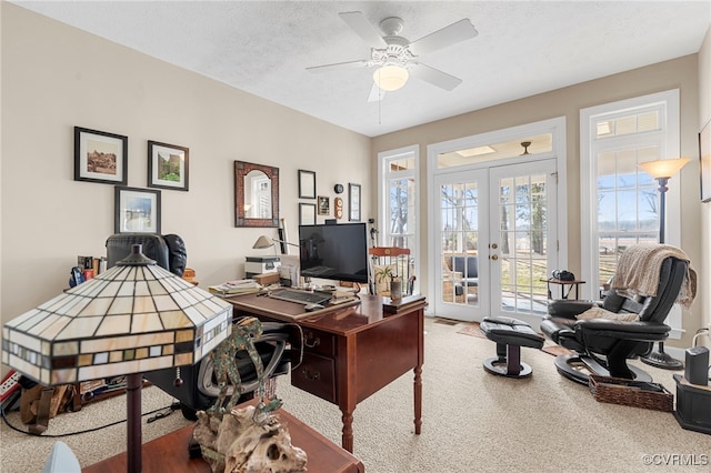 home office featuring a textured ceiling, french doors, carpet flooring, and ceiling fan