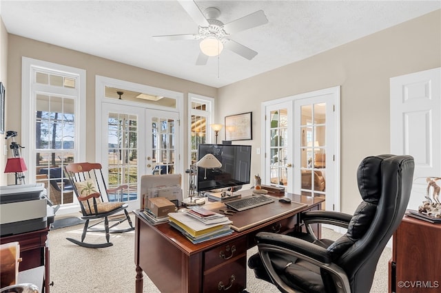 office area with french doors, a ceiling fan, plenty of natural light, and carpet