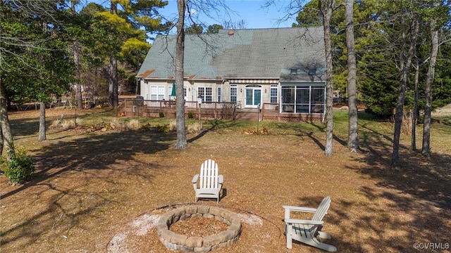 back of property featuring a deck and a sunroom