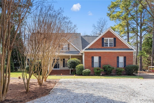 craftsman inspired home with a front lawn and brick siding