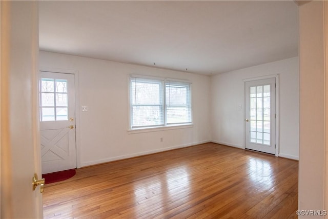 interior space with a healthy amount of sunlight, baseboards, and light wood-style floors