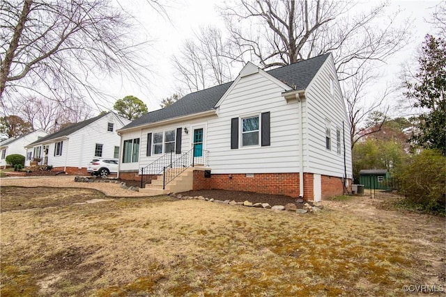 view of front of home with roof with shingles and crawl space