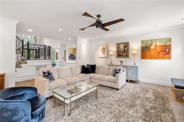 living room featuring recessed lighting, wood finished floors, visible vents, stairway, and crown molding