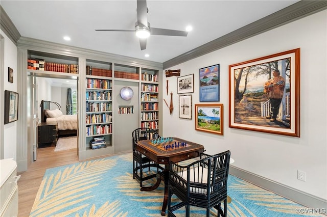 dining room featuring recessed lighting, crown molding, light wood-style flooring, and baseboards