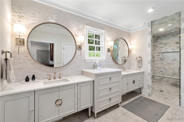 bathroom featuring two vanities, a sink, ornamental molding, a tile shower, and decorative backsplash