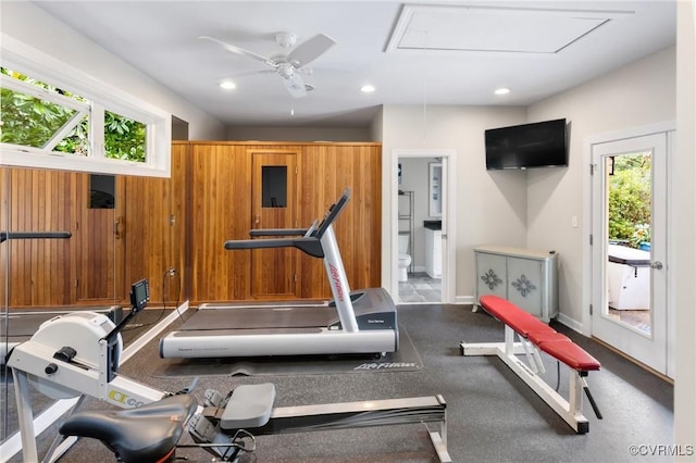 exercise area featuring baseboards, attic access, and recessed lighting