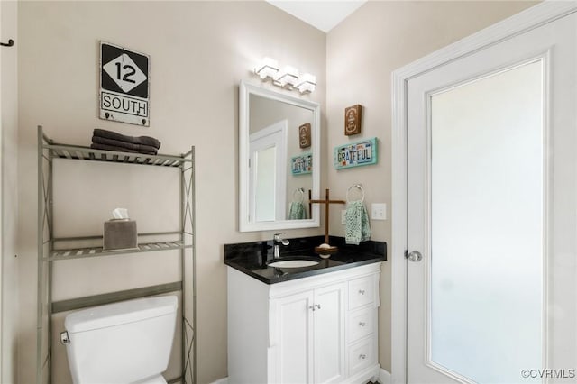 bathroom featuring toilet and vanity