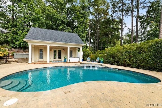 outdoor pool with french doors, a patio, outdoor dry bar, fence, and an outdoor structure