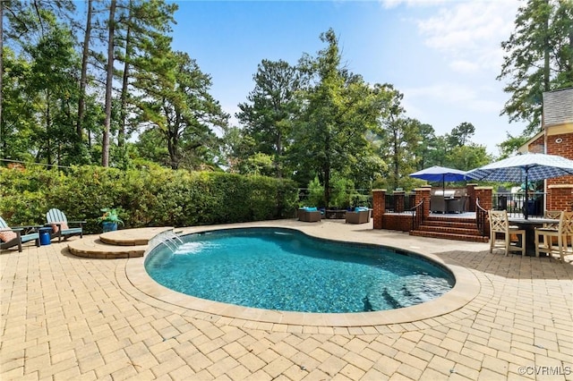 view of pool featuring a fenced in pool, outdoor dining area, a patio area, and a deck