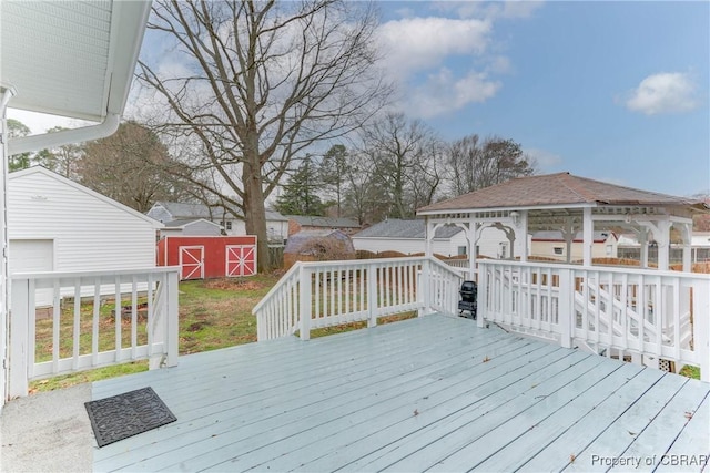 deck featuring an outdoor structure, a gazebo, and a shed