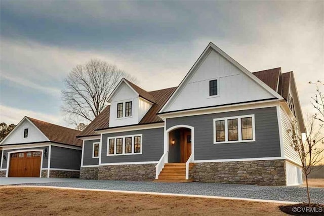 view of front of property with a garage and metal roof