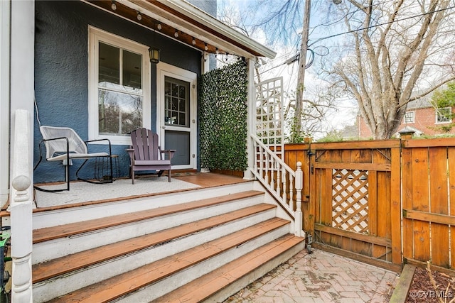 wooden deck featuring fence and covered porch