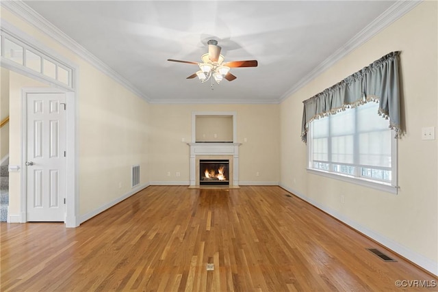 unfurnished living room featuring a fireplace with flush hearth, visible vents, light wood-type flooring, and ornamental molding