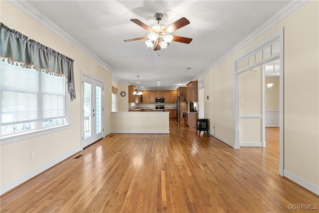 unfurnished living room featuring light wood finished floors, visible vents, french doors, and crown molding