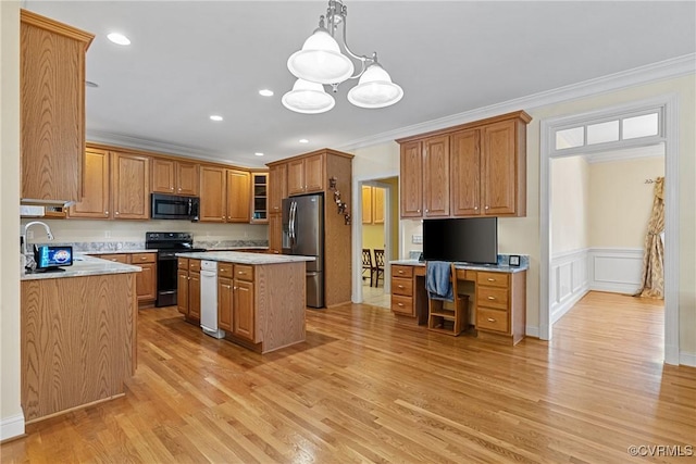 kitchen with ornamental molding, black appliances, light countertops, light wood-style floors, and a center island