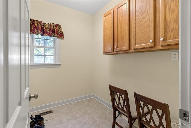 laundry area with baseboards and visible vents