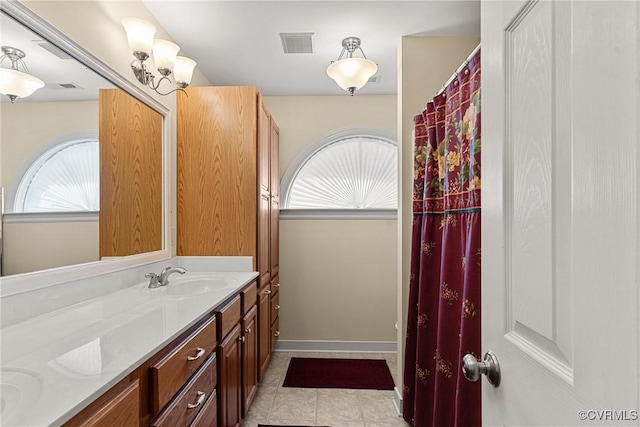 bathroom with vanity, tile patterned floors, baseboards, and visible vents