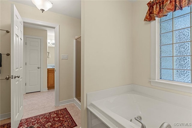 full bath with baseboards, a tub with jets, a stall shower, and tile patterned flooring