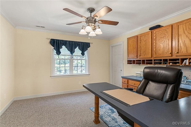 home office with visible vents, a ceiling fan, carpet, crown molding, and baseboards