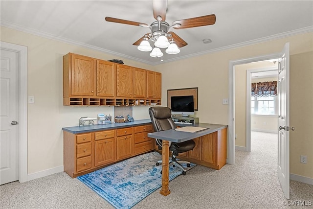 office featuring ceiling fan, crown molding, baseboards, and light carpet