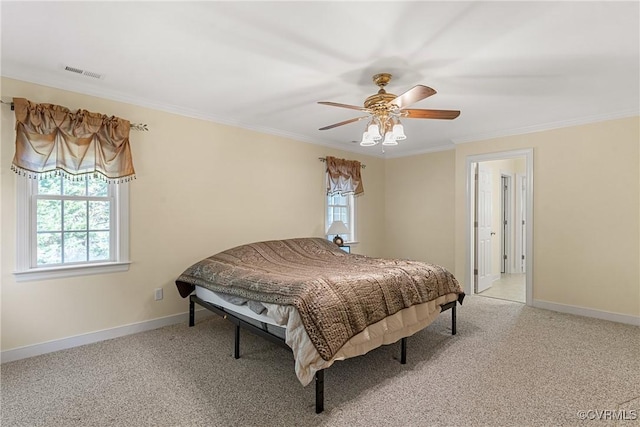 bedroom featuring visible vents, light carpet, baseboards, and crown molding