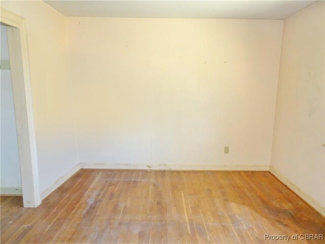 unfurnished room featuring light wood-type flooring and baseboards