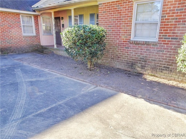 view of exterior entry with brick siding