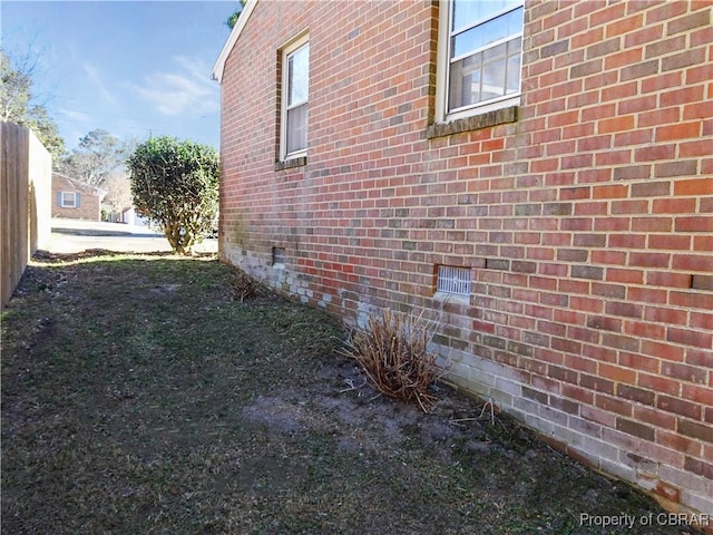 view of side of property featuring brick siding